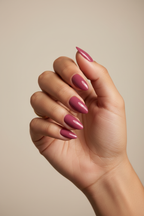 Model wearing deep rose almond press-on nails